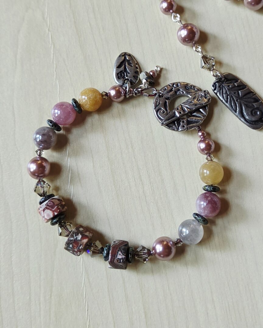 Handmade sunstone and leopard jasper bracelet with Swarovski pearls and floral pewter charm