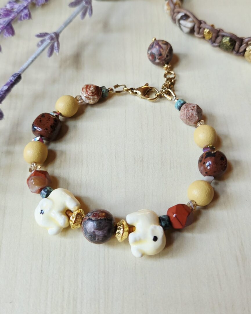 Handmade ceramic elephant gemstone bracelet with leopard skin jasper, red jasper, African turquoise, obsidian, wood and crystal beads.