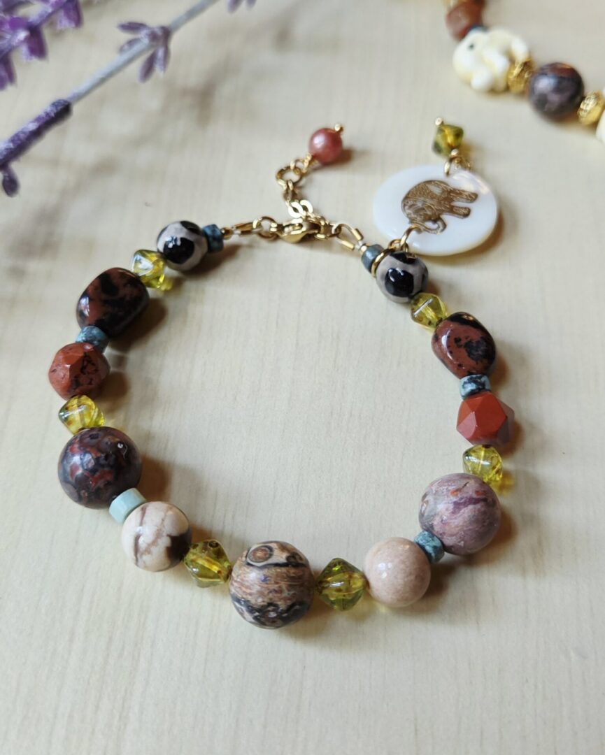 Handmade mother of pearl elephant gemstone bracelet with African turquoise, Dzi beads, obsidian, red jasper, leopard skin jasper, brown zebra jasper and Czech glass beads.
